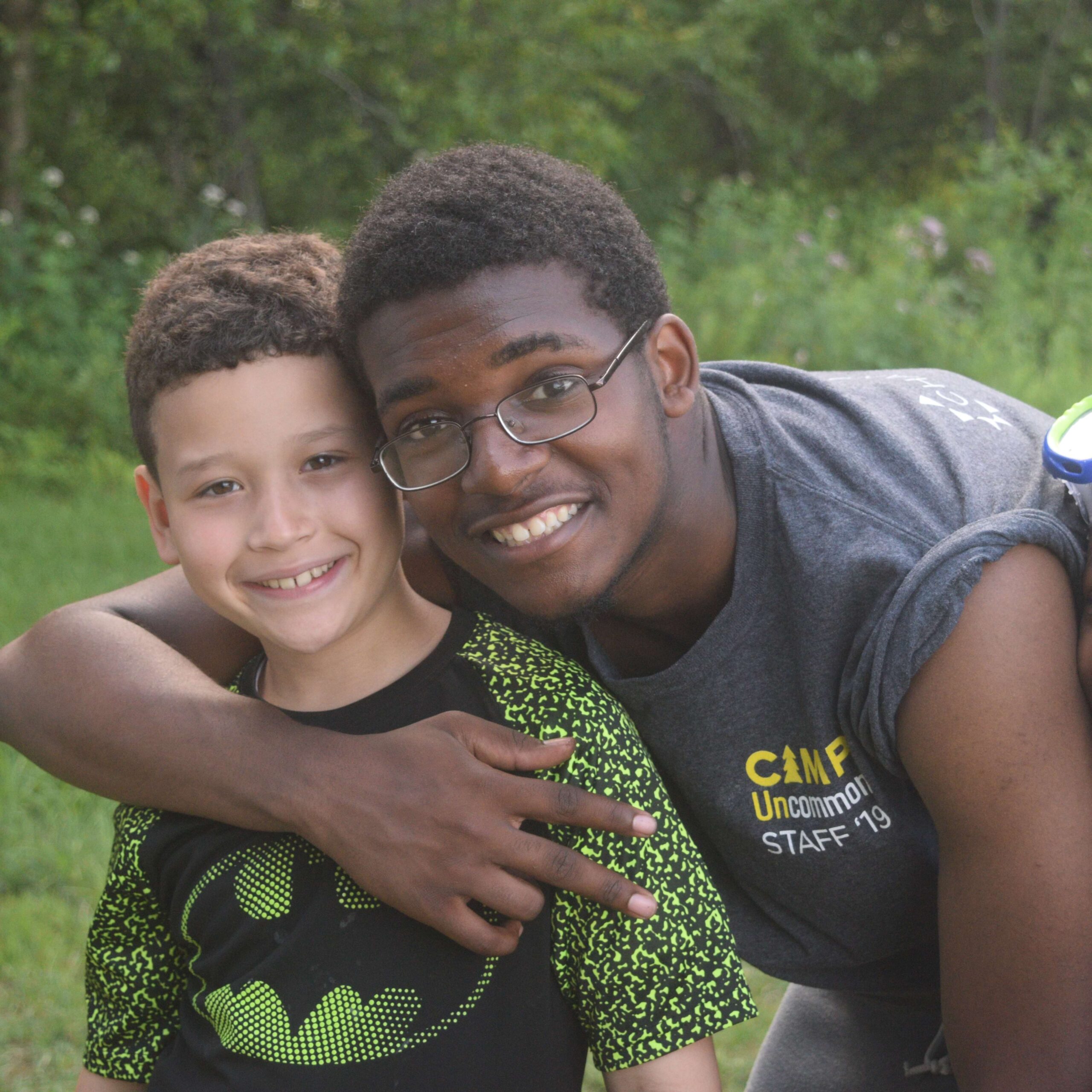 two kids smile for the camera