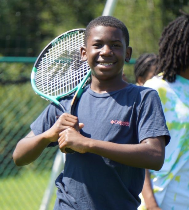 Young boy holding a tennis racquet