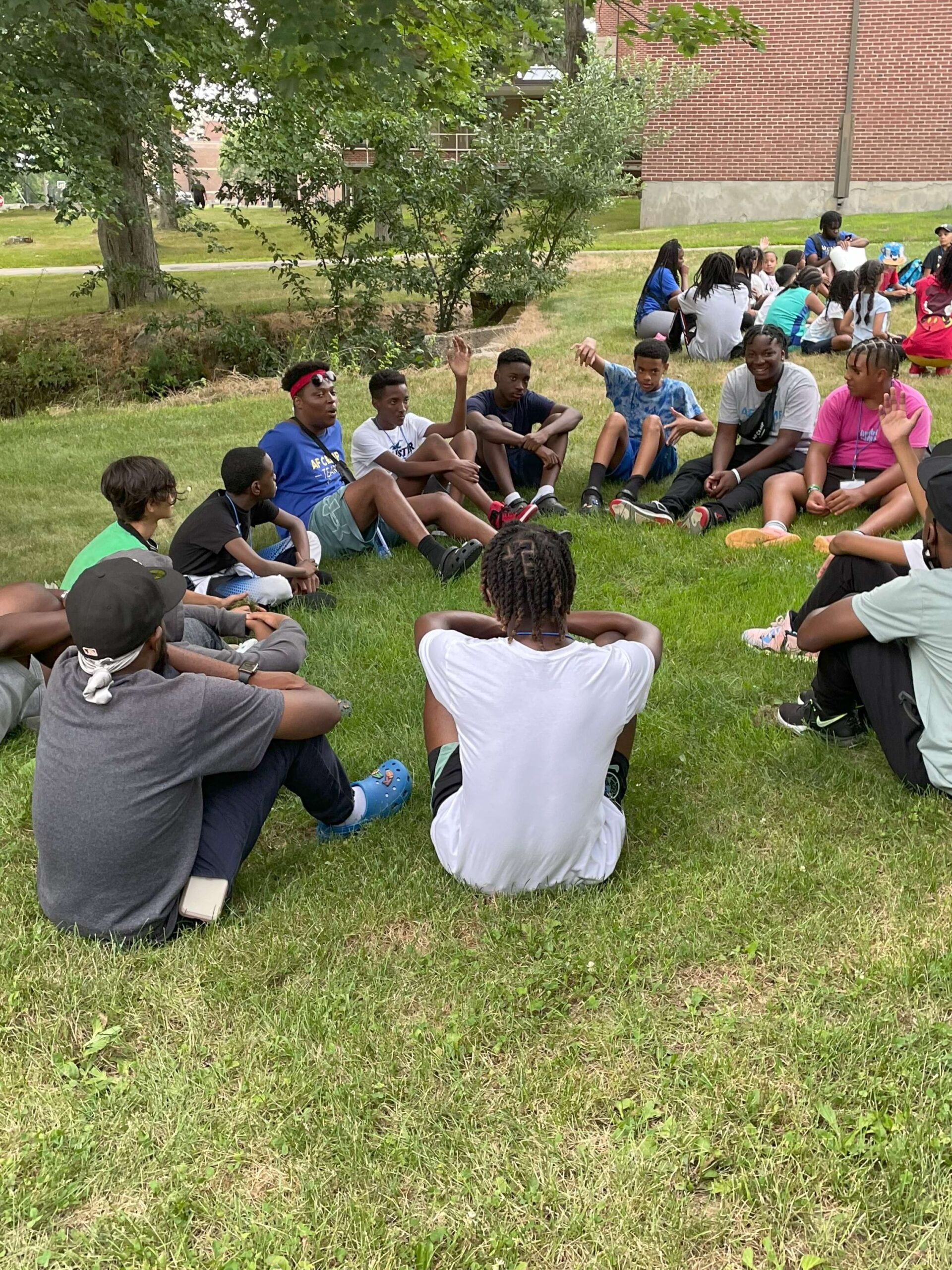 Youth sitting in a circle.