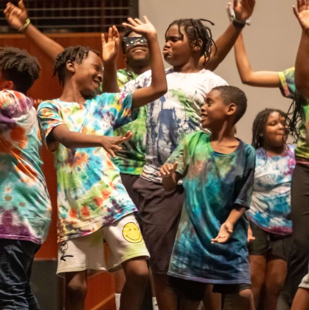Kids dancing on stage.
